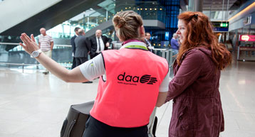 daa staff pink bib helping passenger daa staff pink bib helping passenger