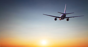 plane in midflight at sunset plane in midflight at sunset